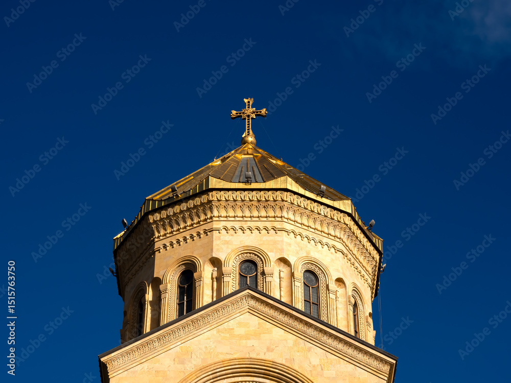 Fototapeta premium The Holy Trinity Cathedral. Tsminda Sameba, close-up cross on the top of the Georgian Orthodox church, beautiful architecture building, famous tourist attraction in Tbilisi, Georgia.