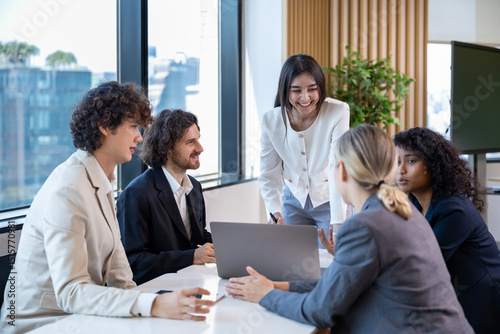 Asian woman sale manager is showing annual report to her colleague in executive meeting for next year plan with market share increase for global business and investment