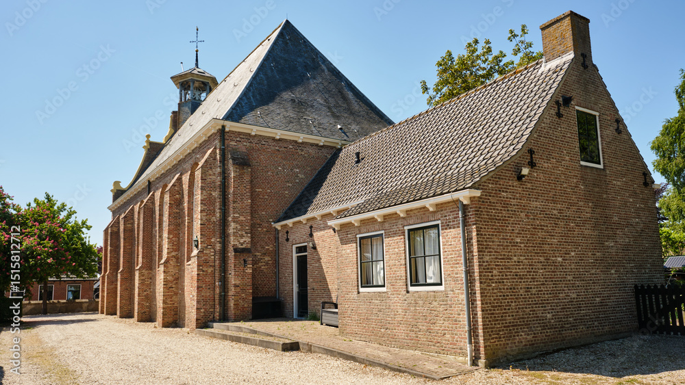 Φωτογραφία Rear view of historic Protestant church with annex in Driewegen, Zeeland