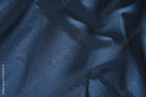 Abstract structure- wrinkles on the fabric. Textile-  simple dark background