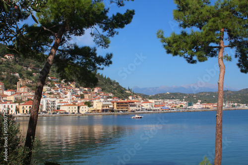 Greek village at the sea with pine trees, summer holiday postcard view (Gythio, Greece) photo