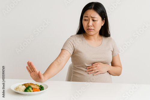 Korean Pregnant Woman with Morning Sickness, Tired Asian Mom-to-Be Feeling Nauseous, Sick Korean Maternity Stock Photo, Morning Sickness in Pregnancy Image, Unwell Asian Pregnant Woman