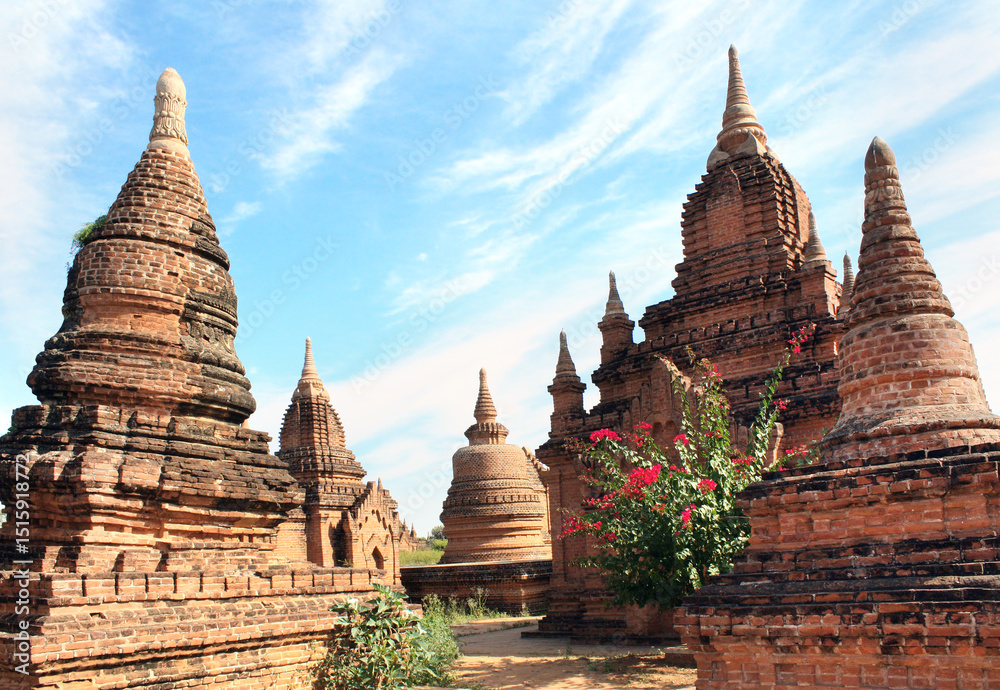Fototapeta premium Famous tourist landmark of Bagan, Myanmar. Ancient stupas in archaeological zone, Bagan, Burma. Topic of vacation, travel, trip abroad on vacation, cruises and tours