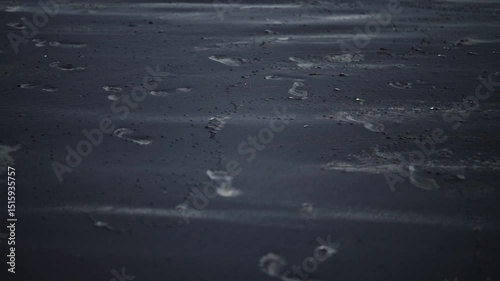 Low close up shot of black sand dunes forming in the wind