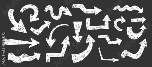 Thick white arrow crayon or chalk drawing sketch grunge textured on blackboard set. Different directions simple curve shape. Pencil, marker, pastel scribble
