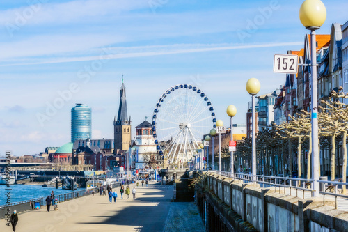 Germany, Dusseldorf, Architecture and Ferris wheel on riverbank