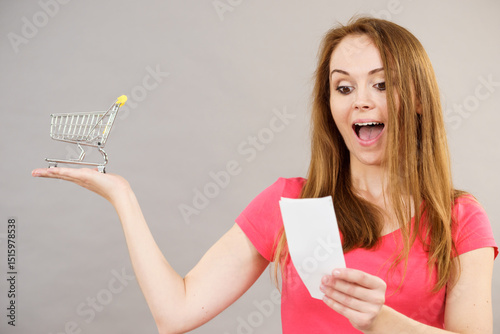 Woman with bill and shopping cart