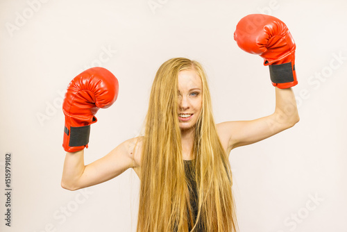Woman in red gloves with arms up