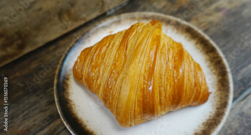 Croissant in dish, Nice dessert on wooden table