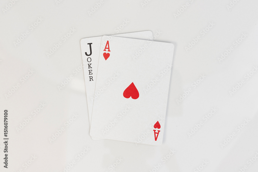 Obraz premium Ace of hearts and black joker card combination on white isolated background