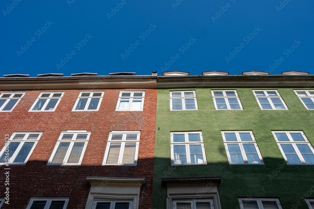 Colorful buildings in central Copenhagen, geometric windows, bold red facades, urban architecture details, cityscape and bright design elements. Colorful buildings in central Copenhagen, geometric windows, bold red facades, urban architecture details, cityscape and bright design elements.