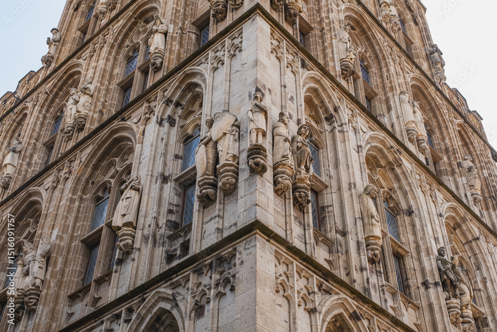 Fototapeta premium Tower of Cologne City Hall with many exterior stone figures seen on every side