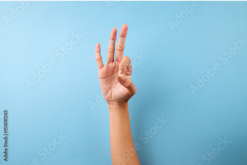 Finger Spelling Letter F In American Sign Language On Blue Background