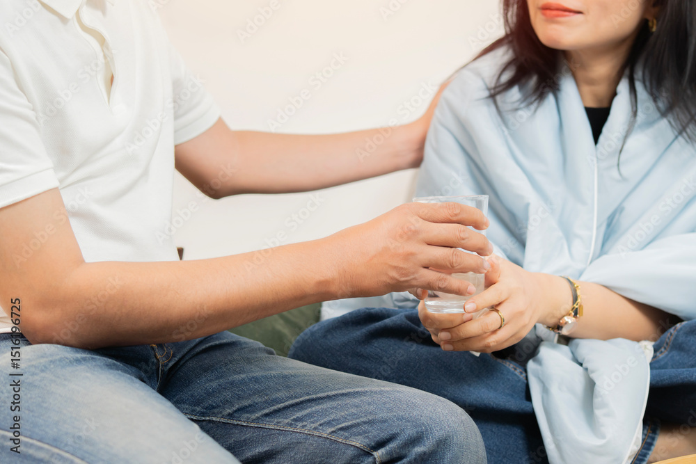 Obraz premium Cropped shot of wife with health problem at home and husband taking care of wife during sicknes