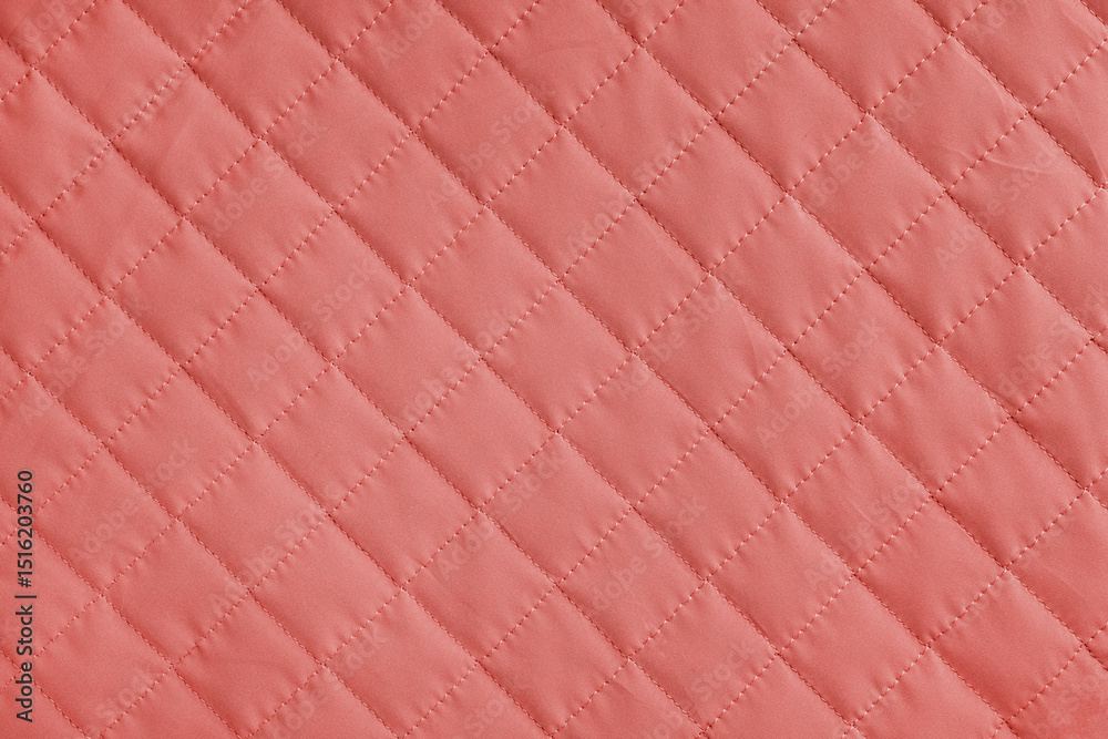 Obraz premium Checkered, diamond stitching pattern, red quilted fabric background. Blanket or puffer jacket, stitch rhombus texture close up, macro. Wallpaper, backdrop.