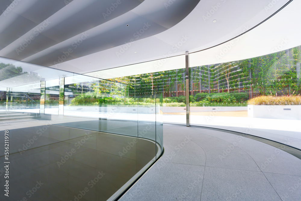 Fototapeta premium Empty corridor beside large glass wall in a modern office building. 3D Rendering
