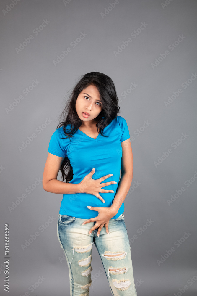 A young woman confidently poses wearing blue t-shirt, distressed denim jeans, heels, showcasing a casual urban style with charm and elegance, suitable for haircare, freedom, self-expression project A young woman confidently poses wearing blue t-shirt, distressed denim jeans, heels, showcasing a casual urban style with charm and elegance, suitable for haircare, freedom, self-expression project