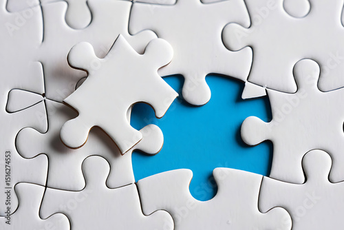 Wallpaper Mural White puzzle pieces and the missing piece a conceptual symbol of completion and problem solving with a blue background Torontodigital.ca