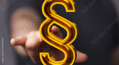 Hand reaching for a 3D golden paragraph symbol.  Legal, law, justice concept.