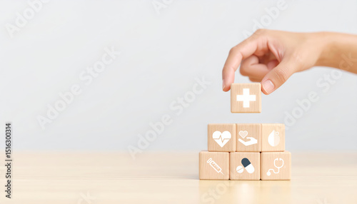 Wallpaper Mural Hand stacking wooden blocks with medical icons including cross heart stethoscope and pills on light wooden table symbolizing healthcare wellness and medical support Torontodigital.ca