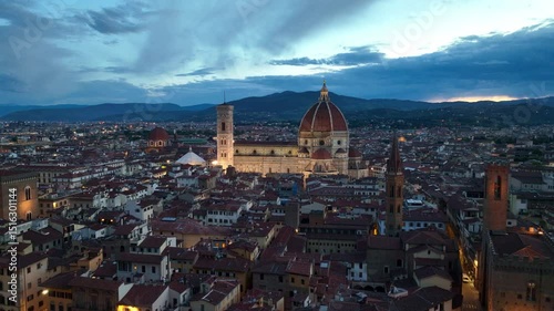flying above Italian city of Florence at night, illuminated renaissance cathedral in Florence, tourist landmark in Tuscany region of Italy