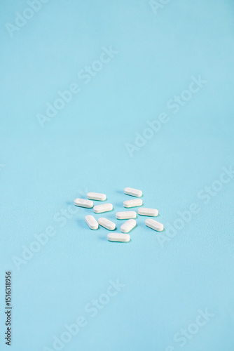 white pills lie on a blue background