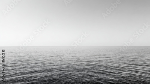 Minimalist black and white photography of a calm sea merging with the clear sky, creating a serene and peaceful atmosphere