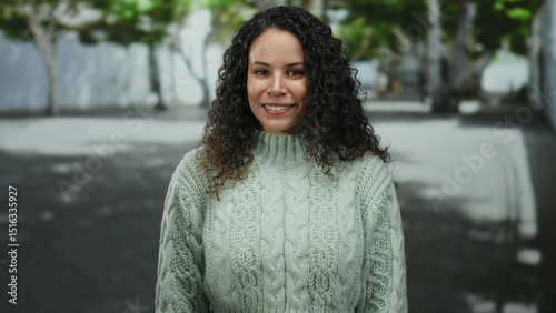 Wallpaper Mural Woman wearing a light sweater smiles outdoors on an urban street surrounded by blurred greenery and trees. Torontodigital.ca