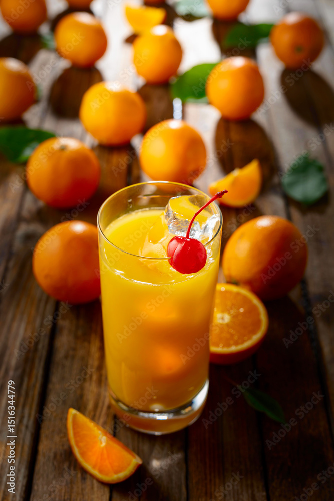 Fototapeta premium Orange juice and fresh fruits on an old wooden table.