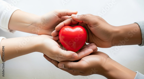 Gentle hands sharing a vibrant red heart symbolizing love care and compassion