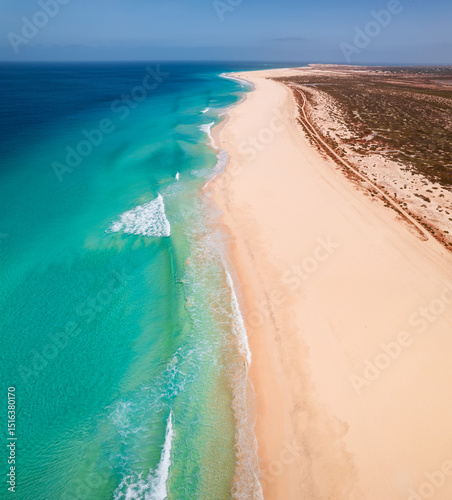 Beautiful tropical beach on Boa Vista Island, Cape Verde, featuring golden sand, clear turquoise water, and a sunny blue sky – ideal travel and vacation destination