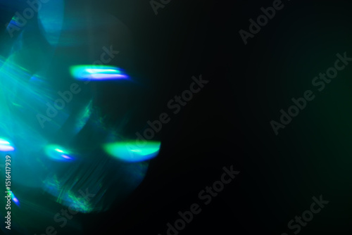 Blurred Light painting one exposure in camera. light glares with a spectral gradient on a dark background.