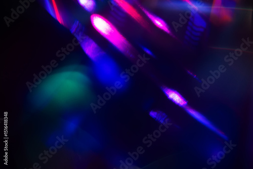 Blurred Light painting one exposure in camera. light glares with a spectral gradient on a dark background.