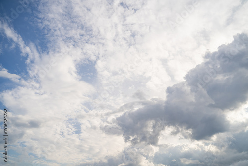 Real majestic bright blue sky with scattered white multilayer clouds on sunny day. Sky view. Skyscape. Peaceful cloudscape with altostratus and cumulus clouds background 