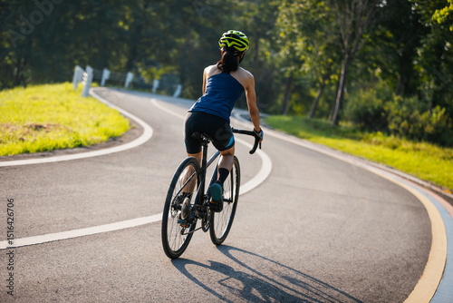 Asian woman cycling in the summer park