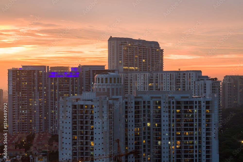 Obraz premium Aerial view of urban skyline of Gurgaon,Haryana,India. Luxury residential apartments and commercial buildings.Colorful sunset in Gurugram city. Modern architecture and premium business hub,Delhi NCR.