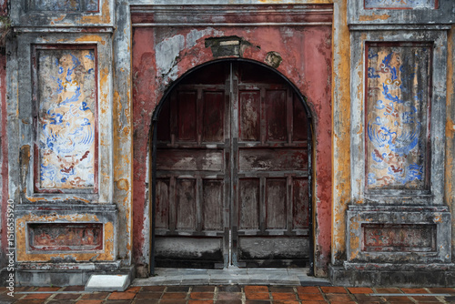 arched closed doors of abandoned ancient colored building and antique ruins. A mystical setting
