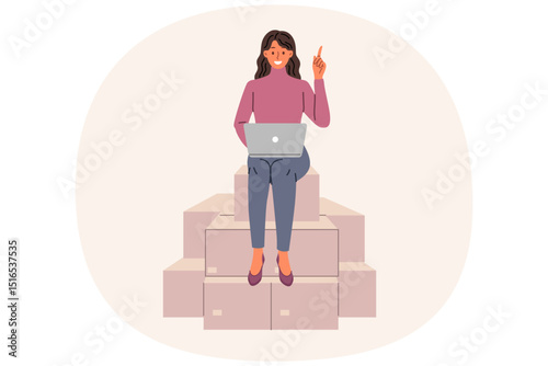 Woman entrepreneur works sitting on cardboard boxes with laptop on lap, sorting and logistics of goods. Happy girl with computer smiling and pointing finger up, enjoying entrepreneur routine