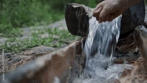 Wallpaper Mural A woman touches crystal clear spring with her hand, gently flowing water, bringing peace and freshness Torontodigital.ca