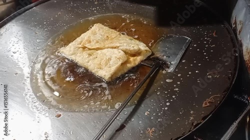 Egg martabak in the frying process.