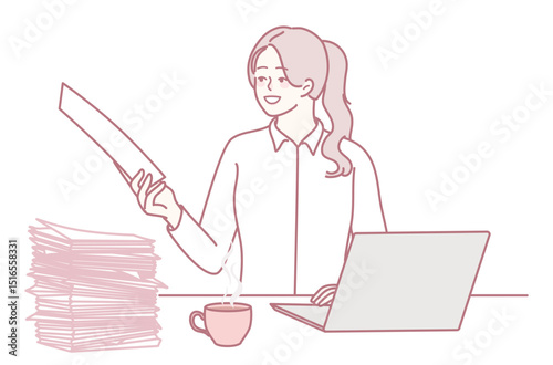 A woman is focused on reviewing documents at her organized workspace, with a laptop and coffee cup beside her