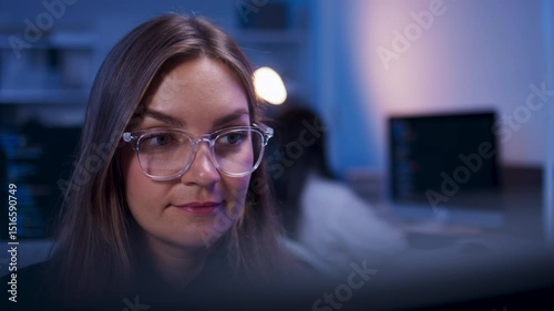 Focused Caucasian Female Frontend Developer Working on desktop computer, Writing and Reviewing Code in a modern Development office. Woman Developer Working, Solving Technical Problems Debugging Code.