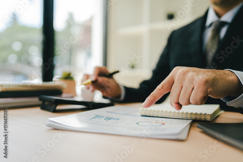 Close-up of hands working with computer tablet in modern office. Preparing accounting analysis report, real estate investment information, financial and tax system concept.