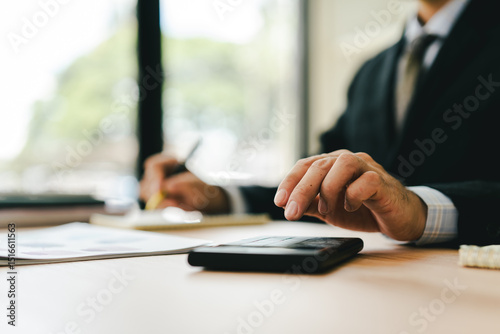 Close-up of hands working with computer tablet in modern office. Preparing accounting analysis report, real estate investment information, financial and tax system concept.