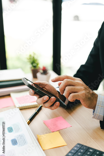 Portrait working on smartphone and calculating tax in modern office. Preparing accounting analysis report, real estate investment information, financial and tax system concept.