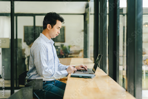 Portrait of a young man working in a coffee shop. Employees are taking a break during lunch break in a coffee shop.