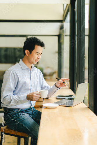 Portrait of a young man working in a coffee shop. Employees are taking a break during lunch break in a coffee shop.