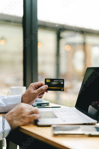 Portrait of entering credit card information on a laptop. Shopping online credit card login