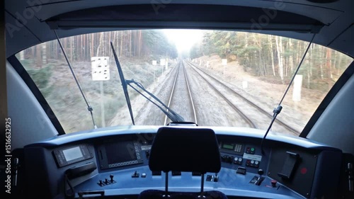 View through the windshield in the driver's cabin of a moving train