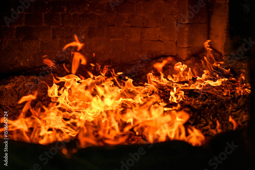 Close-up view of blazing fire inside a temple furnace burning joss paper during a traditional Taiwanese worship ritual